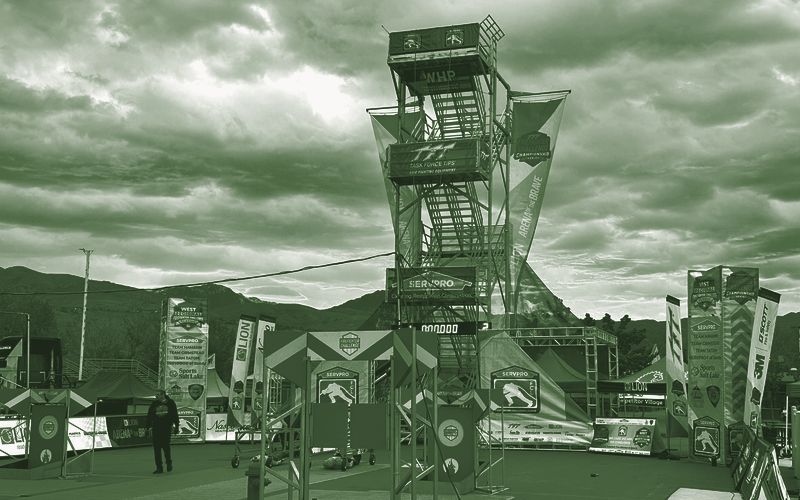The Firefighter Challenge tower and course set up before dawn, with timing displays at the base of the tower.